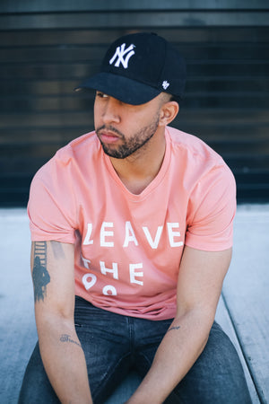 Man with I love New York hat wearing Leave The 99 sunset stylish unisex tshirt.  Awesome Jesus shirt. 